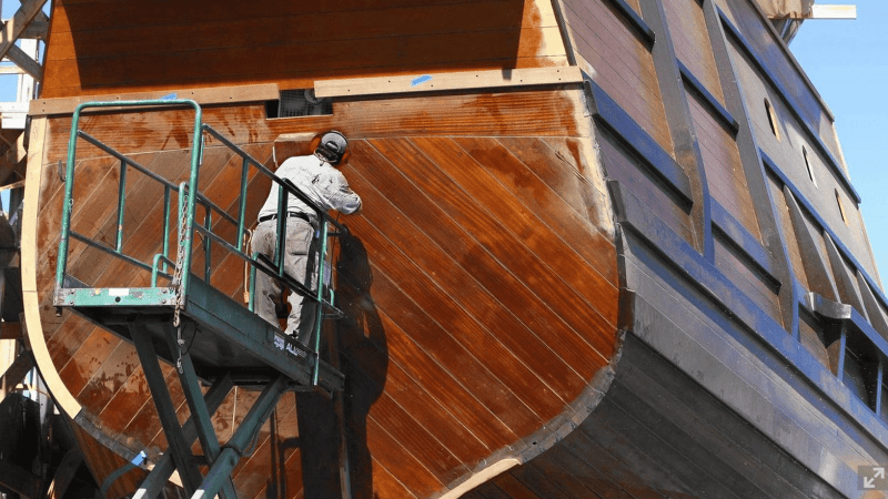 Carpenter Robert Phillips works on the rudder assembly of a full-scale replica of the San Salvador, the flagship of Portuguese explorer Juan Cabrillo.