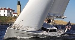 Brigadoon VII's white cruising sails (she wears black when racing) and prominent deckhouse don't disguise the cut-and-thrust intent designed into her sharp plumb bow.