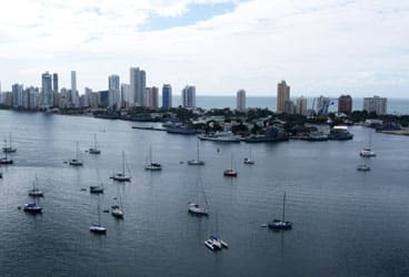 Cruising boats can dodge hurricane season in the harbor at Cartagena, Colombia. Beyond, the high-rises of the city’s Bocagrande business and tourism center contrast with the Old City’s colorful Spanish colonial charms.