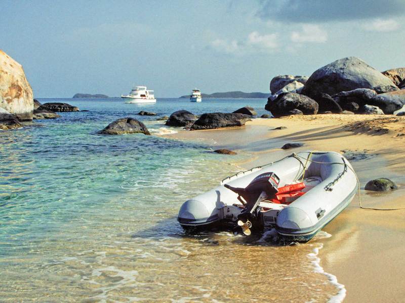 Tender_3_edit Inflatable boat with motor on shore