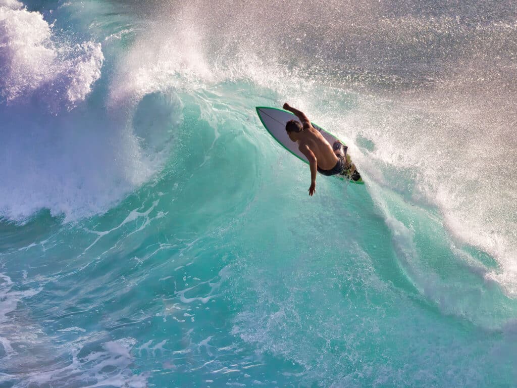 Person surfing in an ocean curl