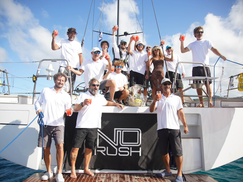 The crew of first ARC 2024 boat to finish, Southern Wind 105GT No Rush enjoy a welcome rum punch