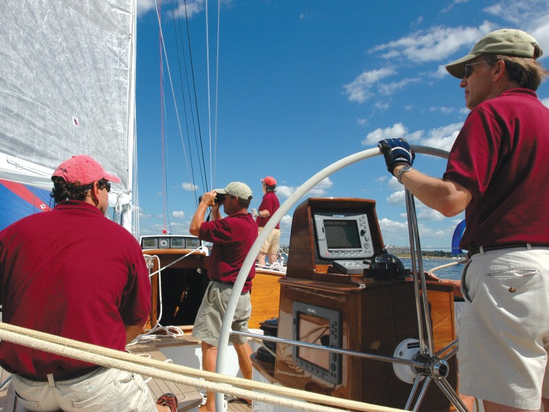 1-18 Man steering a sailboat