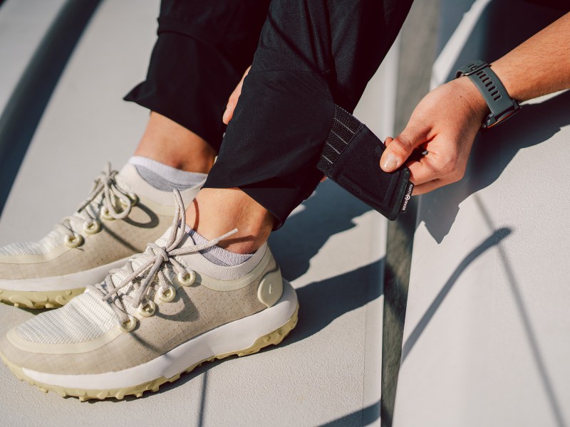 Woman adjust a strap on her pant leg