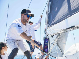 Sailor adjusting the rigging during a race