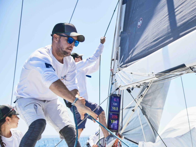 Sailor adjusting the rigging during a race