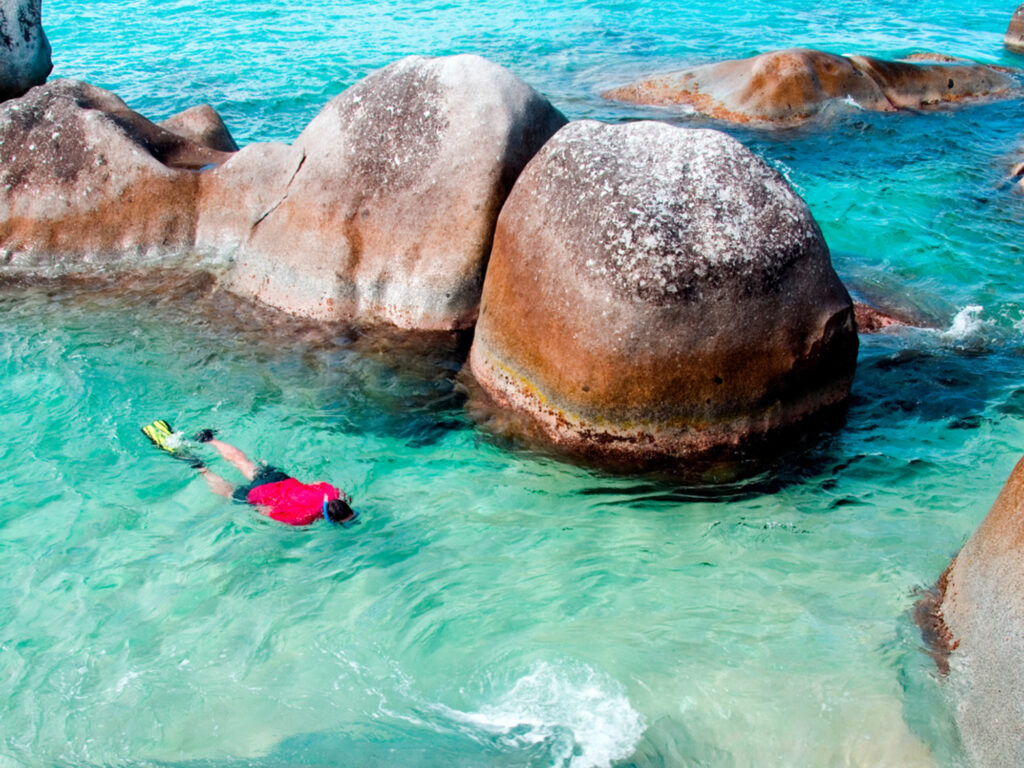 Person snorkeling in clear waters