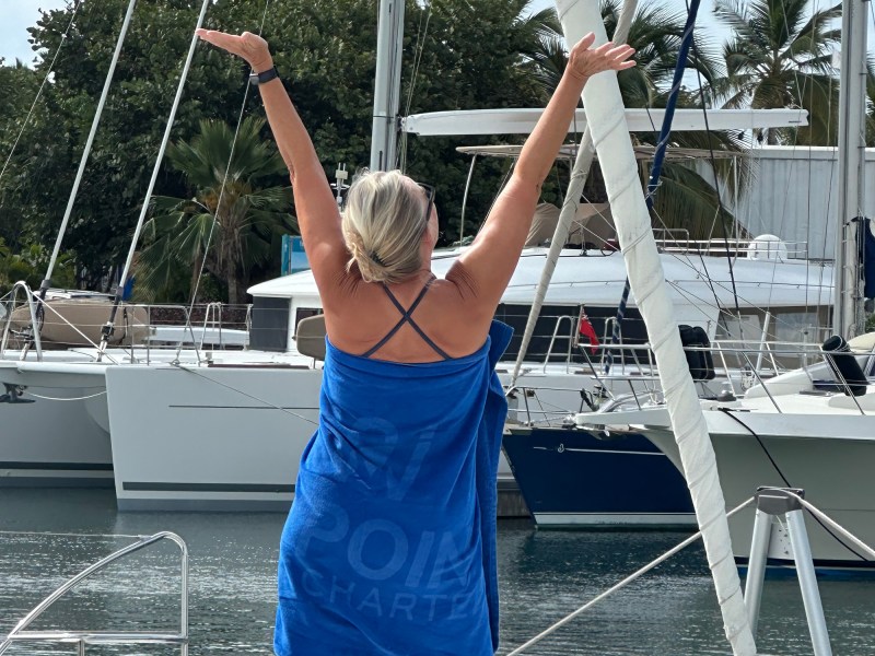 Woman raising her arms at a marina