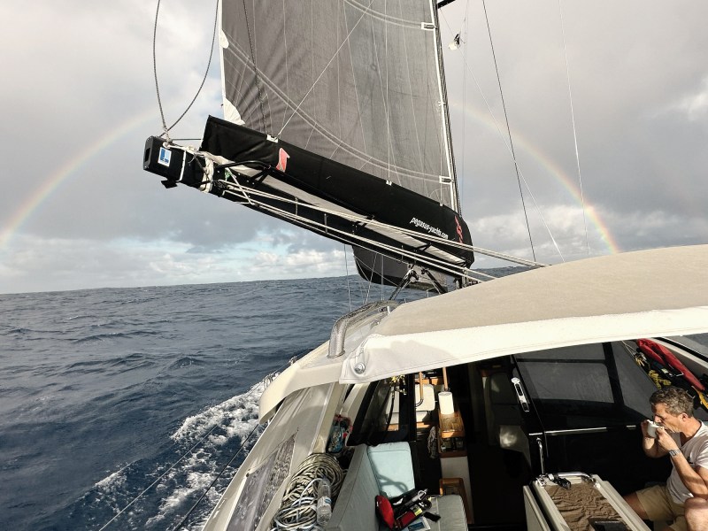 Sailboat with rainbow over the horizon