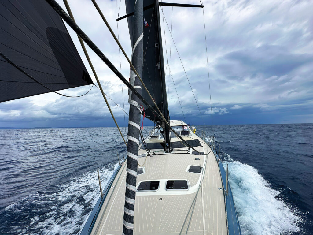 Sailboat departing the mainland