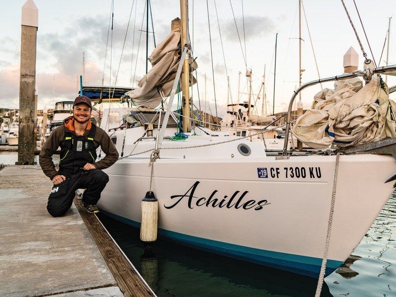 Man next to a sailboat at dock
