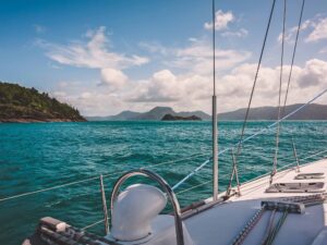 Sailboat sailing on a warm beautiful day in the Whitsunday Islands on the Great Barrier Reef in Australia.