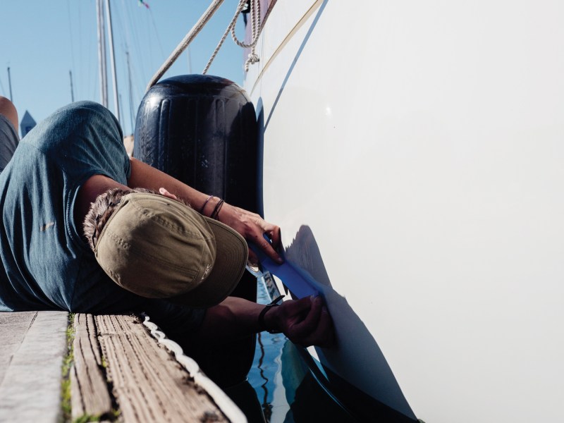awlgrip-repair Chris Neely prepping for repair of a sailboat