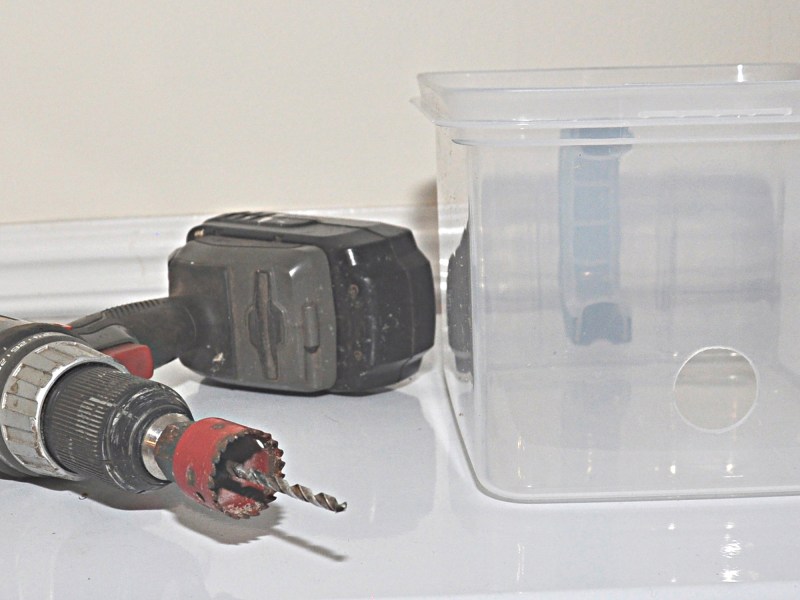 drill and container for drain box