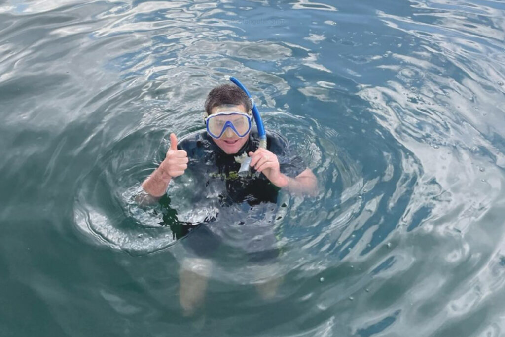 man snorkeling in water