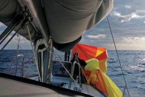 Michael retrieves and stows the shredded spinnaker
