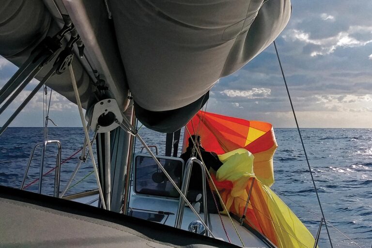 Michael retrieves and stows the shredded spinnaker