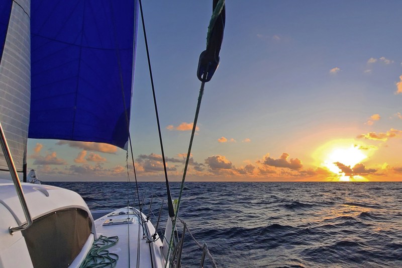 Sailboat on open water at sunset