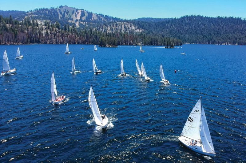 The club racing fleet scoots across the lake beneath China Peak