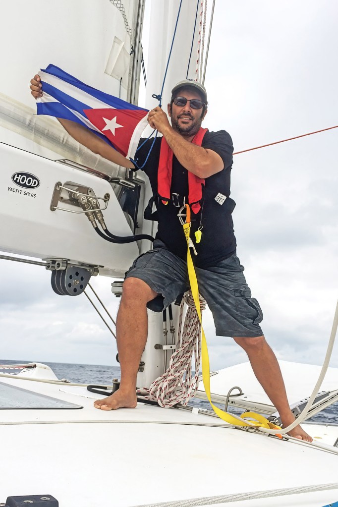 Capt. Will Rey prepares to hoist the Cuban courtesy flag