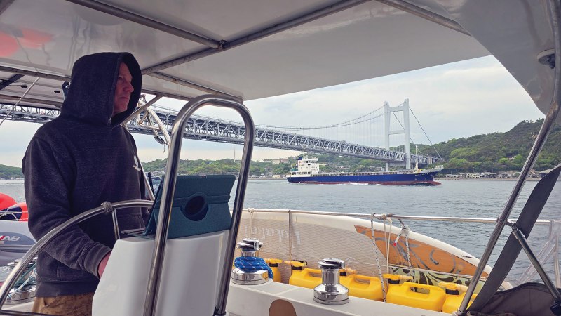 A sailor navigates a canal with AIS data on a tablet